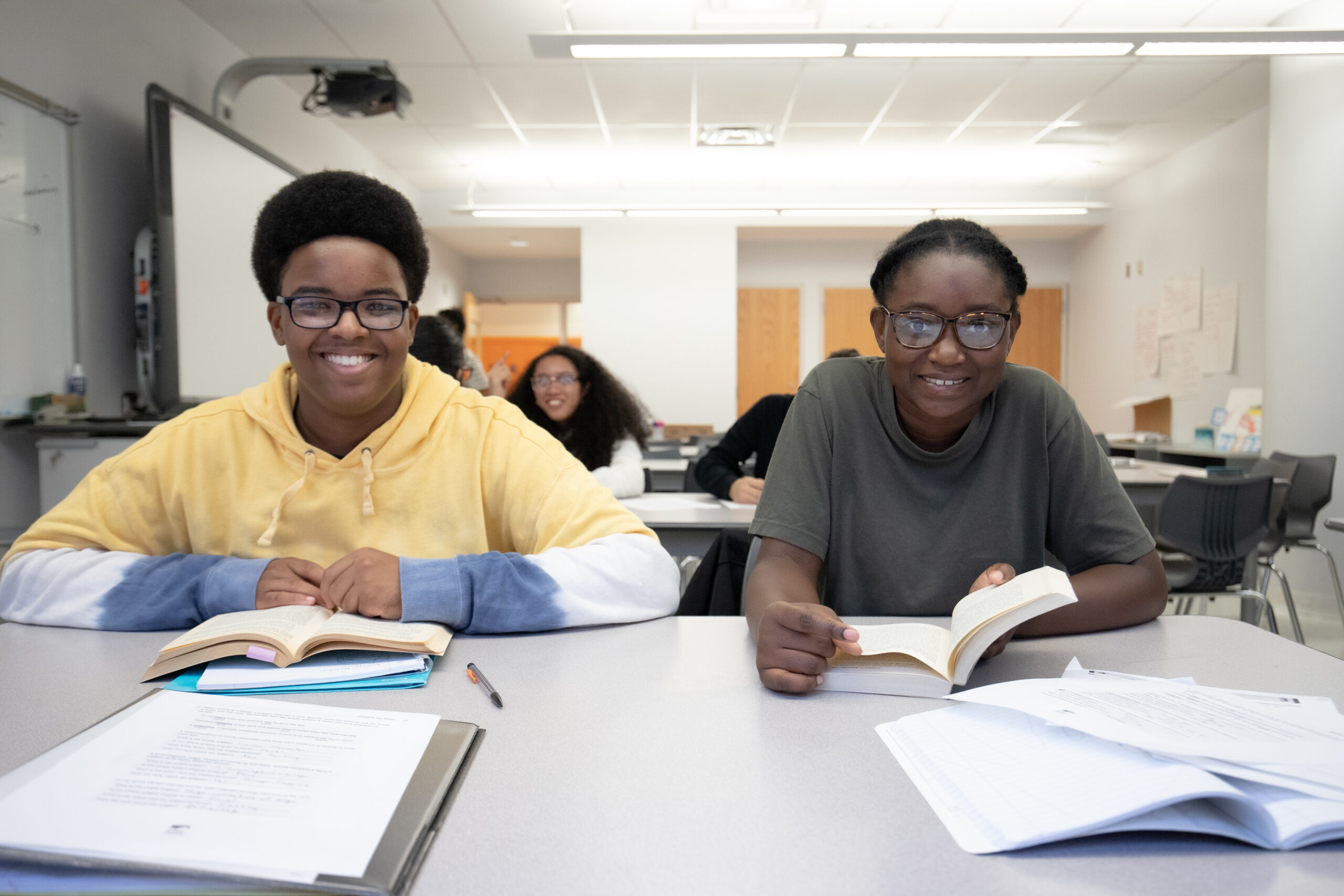 A boy and girl sitting with open books in front of them