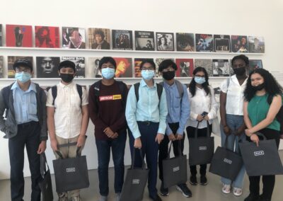Students standing in front of a wall of albums at Pace Gallery